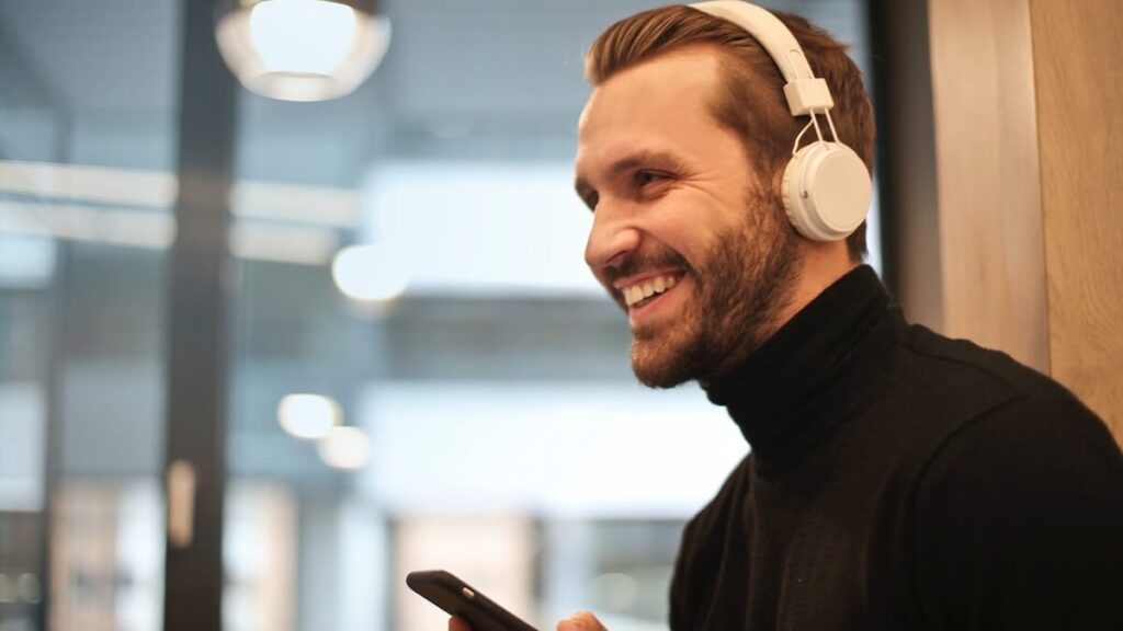 O que significa kkkk no WhatsApp: Confira mais aqui! 5 Homem de fones de ouvido rindo