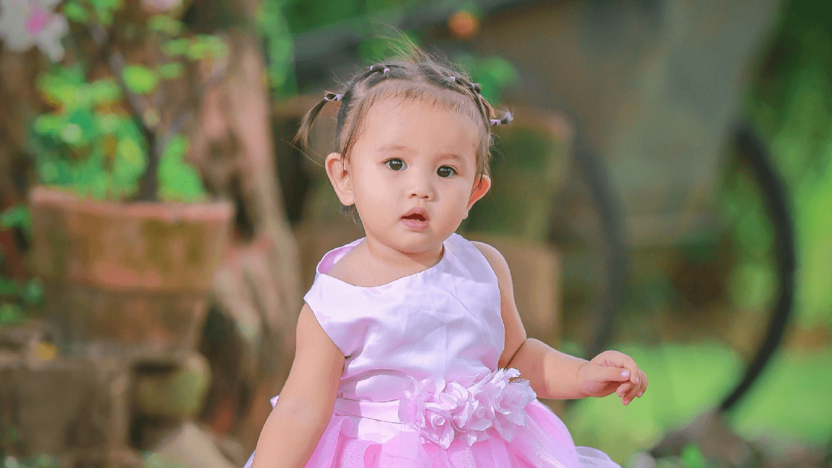 Nomes femininos com C, menina de vestido rosa