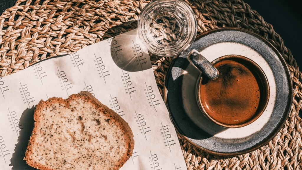 Combinações nutritivas para acompanhar seu café da manhã 1 Café da manhã com um pão, um copo de água e com café.